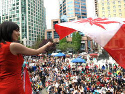 Activist Jodie Emery waves the Cannabis-Canada flag for thousands of stoney supporters at the Vancouver Art Gallery.
